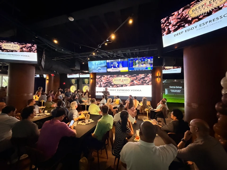 Guests gathered at PSC tables for a presentation across the room screens