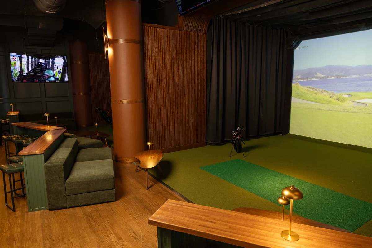 A PSC sports suite with green seating, brass table lights and an open back